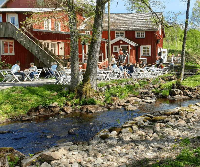 Rött hus bredvid en å.